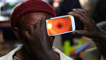 A woman undergoes an eye examination using a smartphone at a temporary clinic in the Mau Summit 350km (217 miles) west of Kenya's capital Nairobi(Reuters/Noor Khamis)