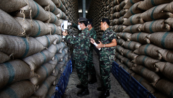 Soldiers check sacks of rice at a warehouse in Ayutthaya province, north of Bangkok (Reuters/Chaiwat Subprasom)