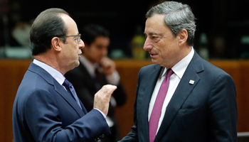 ECB President Mario Draghi talks with France's President Francois Hollande during an EU summit in Brussels (Reuters/Christian Hartmann)