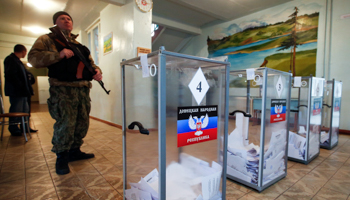 A pro-Russian separatist stands guard during the self-proclaimed Donetsk People's Republic elections (Reuters/Maxim Zmeyev)