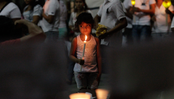 A girl holds a candle during a protest for the 43 missing students of the Ayotzinapa Teacher Training College (Reuters/Daniel Becerril)