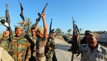 Shi'ite fighters and Iraqi army members celebrate after taking control of Jurf al-Sakhar from Islamic State militants (Reuters/Alaa Al-Marjani)