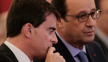 Francois Hollande speaks with Manuel Valls during a ceremony at the Elysee Palace in Paris (Reuters/Philippe Wojazer)