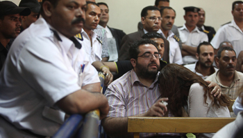 Friends of Egyptian suspects listen to the judge's verdict during a case against foreign NGOs in Cairo (Reuters/Asmaa Waguih)