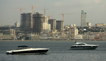 Speedboats sit beneath the backdrop of Luanda (Reuters/Rafael Marchante)