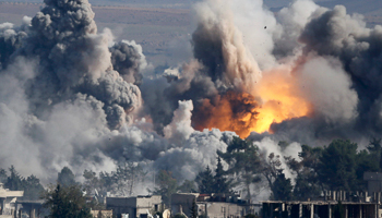 Smoke rises over Syrian town of Kobani after an airstrike (Reuters/Kai Pfaffenbach)