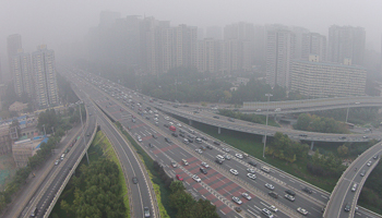 Vehicles drive along the residential buildings on Beijing's Fourth Ring Road (Reuters/Jason Lee)