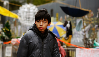 Student leader Joshua Wong, on a hunger strike, walks past a protest site outside the government headquarters in Hong Kong (Reuters/Bobby Yip)