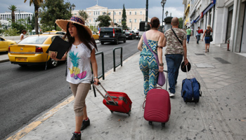 Tourists make their way around central Syntagma square in Athens (Reuters/Yorgos Karahalis)
