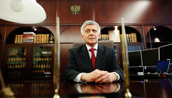 Central bank Governor Marek Belka sits at his desk at the bank's headquarters in Warsaw (Reuters/Kacper Pempel)
