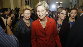 Elizabeth Warren, flanked by Senator Debbie Stabenow and Senator Amy Klobuchar, after a leadership election for Congress in Washington (Reuters/Jonathan Ernst)