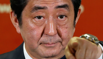 Abe points to a reporter during a news conference, at the LDP headquarters in Tokyo (Reuters/Toru Hanai)