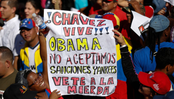 Supporters of Venezuela's President Nicolas Maduro hold a banner during a rally to reject the sanctions that the US government seeks to impose on officials accused of human rights violations (Reuters/Carlos Garcia Rawlins)