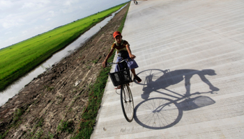 A boy rides his bicycle at the construction site of the Thilawa economic zone outside Yangon (Reuters/Soe Zeya Tun)