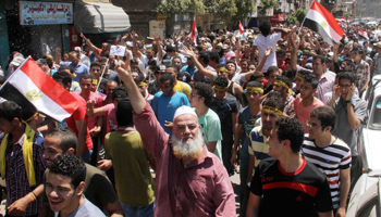 Supporters of Egypt's former president Mohamed Mursi shout slogans and make the "Rabaa" four-fingered gesture during a protest in Cairo (Reuters/Al Youm Al Saabi Newspaper)