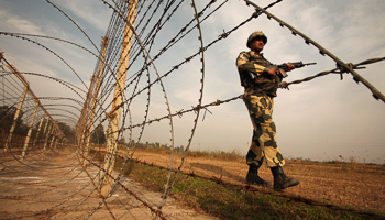 An Indian Border Security Force soldier patrols near the border with Pakistan in Suchetgarh, southwest of Jammu (Reuters/Mukesh Gupta/Files)