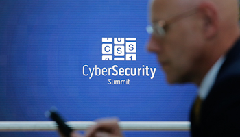 A man checks his mobile electronic device during the Cyber Security Summit 2014 in Bonn, Germany (Reuters/Ina Fassbender)