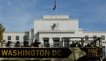A tour bus passes the US Federal Reserve building (Reuters/Gary Cameron)