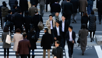 Pedestrians cross a street at a business district in Tokyo (Reuters/Toru Hanai)