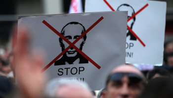 People hold banners during opposition rally to protest against Russia's policy towards Georgia and Ukraine (Reuters/David Mdzinarishvili)