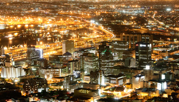 Cape Town's business district lights up as dusk falls over the city (Reuters/Mike Hutchings)