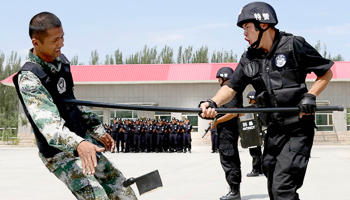 Policemen at an anti-terrorist drill in Xinjiang, China (Reuters/China Daily)