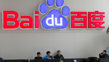 People sit in front of the company logo of Baidu in Beijing (Reuters/Kim Kyung-Hoon)