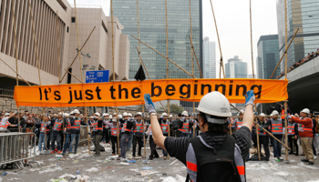 Workers clean up after an area was blocked by pro-democracy protesters (Reuters/Tyrone Siu)