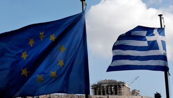 The European Union and Greek national flags in front of the Parthenon temple in Athens (Reuters/Alkis Konstantinidis)