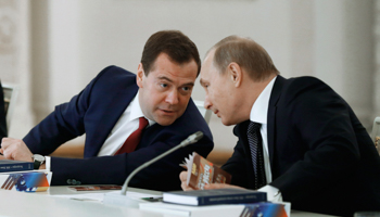 President Vladimir Putin listens to Prime Minister Dmitry Medvedev (Reuters/Dmitry Astakhov/RIA Novosti/Pool)