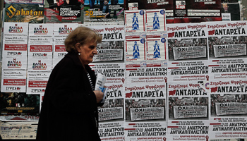 A woman walks past electoral posters in Athens (Reuters/Alkis Konstantinidis)