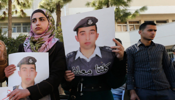 Students hold pictures of Jordanian pilot Muath al-Kasaesbeh during a rally calling for his release (Reuters/Muhammad Hamed)