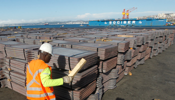 A port worker checks a shipment of copper that is to be exported to Asia (Reuters/Rodrigo Garrido)