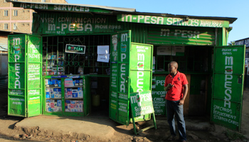 A man waits for M-Pesa customers at his shop in Kibera (Reuters/Noor Khamis)