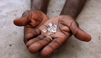 An illegal diamond dealer from Zimbabwe displays diamonds for sale in Manica (Reuters/Goran Tomasevic)