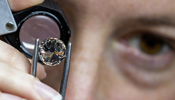 A worker inspects a diamond at the Antwerp World Diamond Centre (Reuters/Yves Herman)