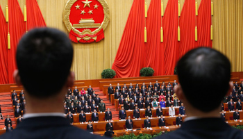 Security personnel stand guard as China's President Xi Jinping sings Chinese national anthem with other delegates (Reuters/Kim Kyung-Hoon)