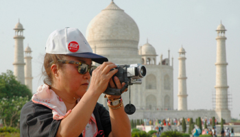 A tourist takes a photograph in front of the Taj Mahal in the tourist city of Agra (Reuters/Brijesh Singh)