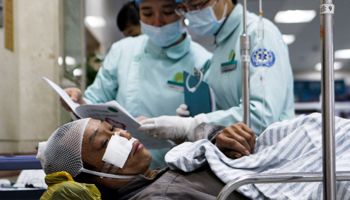 A person injured after a factory explosion is treated at a hospital in Foshan, Guangdong province (Reuters/Stringer)