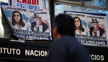 Posters of Argentina's President and Thomas Griesa, depicted as Uncle Sam, in Buenos Aires (Reuters/Marcos Brindicci)