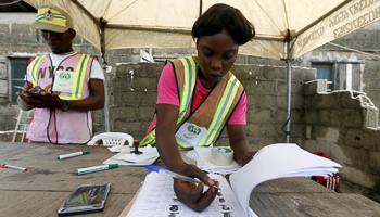 An electoral officer checks a list of voters in the Ajah district of Lagos (Reuters/Akintunde Akinleye)