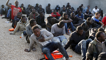 Illegal migrants sit in a coastal police base in Tripoli (Reuters/Goran Tomasevic)