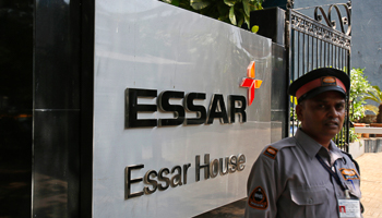 A security guard next to an Essar Group logo outside the headquarters in Mumbai  (REUTERS/Vivek Prakash) 