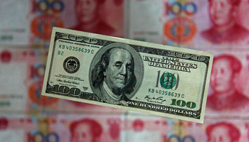 A 100 dollar banknote placed above Chinese 100 yuan banknotes in Beijing (Reuters/Petar Kujundzic)