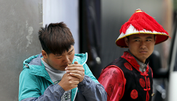 A man smokes at a shopping district in Beijing (Reuters/Kim Kyung-Hoon)