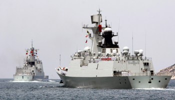 Chinese destroyer Haikou and missile frigate Yueyang depart from Hainan province (Reuters/Stringer)
