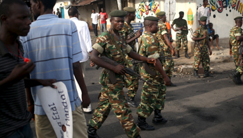Soldiers pass protesters during a demonstration against  Burundi President Nkurunziza (Reuters/Goran Tomasevic)