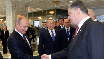 Putin shakes hands with Poroshenko in Minsk (Reuters/Sergei Bondarenko/Kazakh Presidential Office)