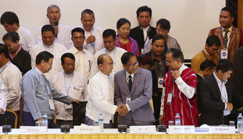 President Thein Sein and Naing Han Tha, a leader of the NCCT, shake hands at the Myanmar Peace Centre in Yangon (Reuters/Stringer)