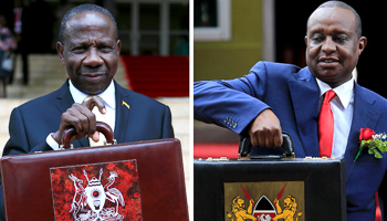 Kenya's Finance Minister Henry Rotich and Uganda Minister of Finance Matia Kasaija hold briefcases carrying their national budgets (Reuters/Noor Khamis/James Akena)
